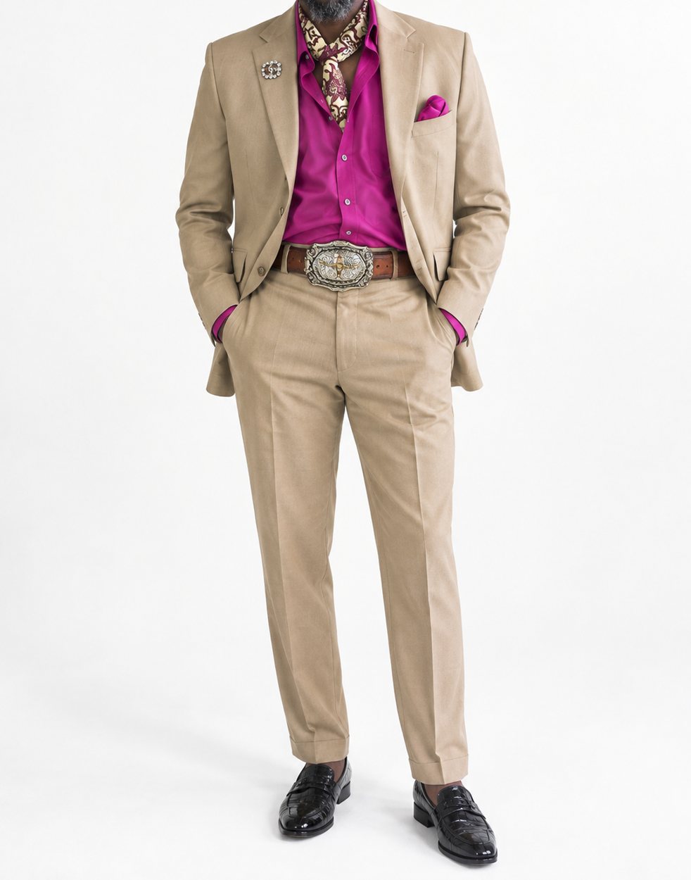 Camel suit with a magenta shirt, a paisley scarf, a silver buckle belt and black croc loafers